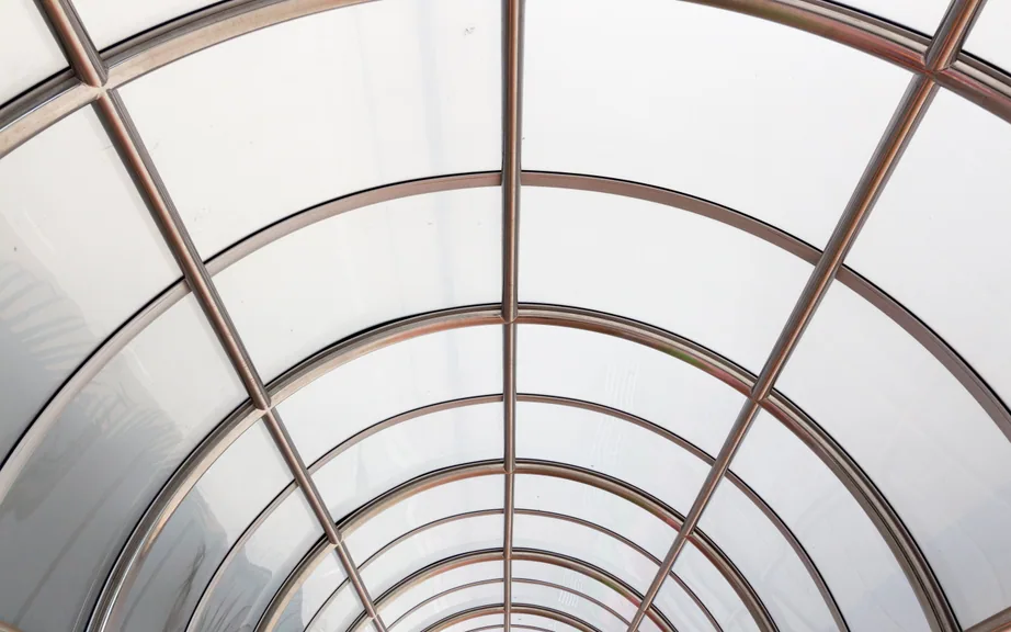 Curved roof framing a translucent barrel-vault skylight
