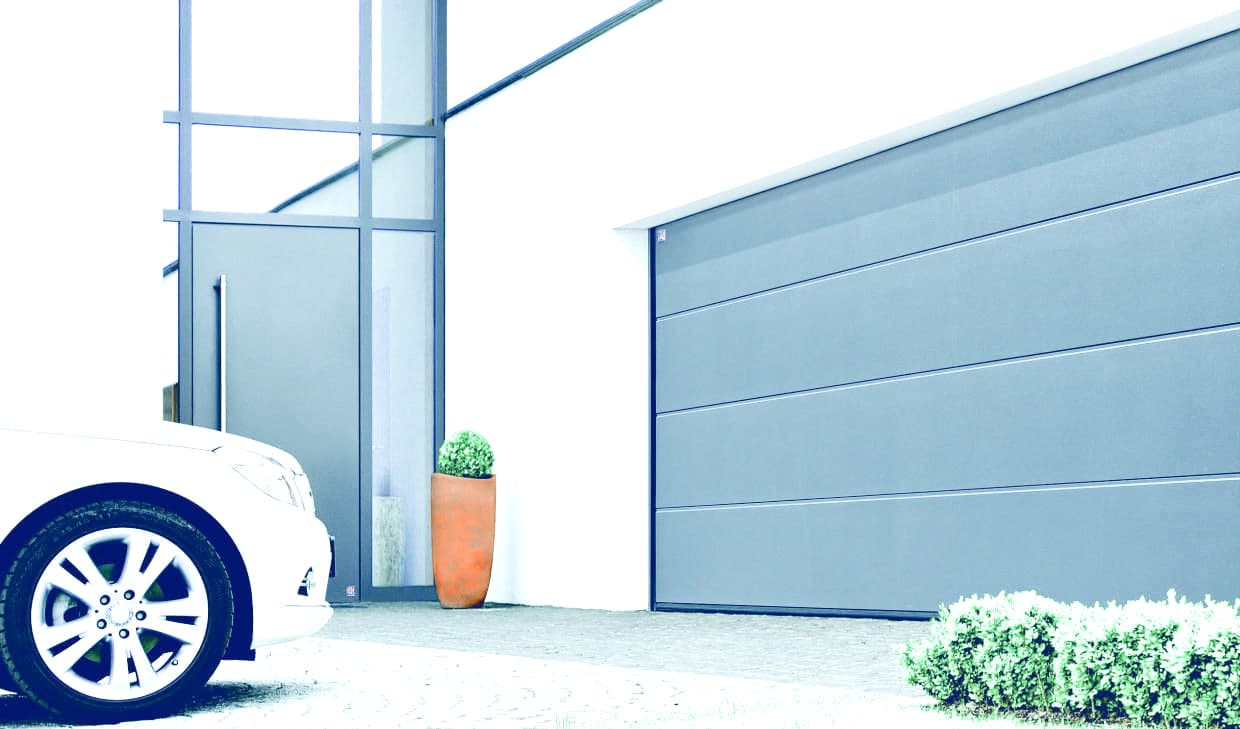 Remote-operated sectional garage door on a modern house