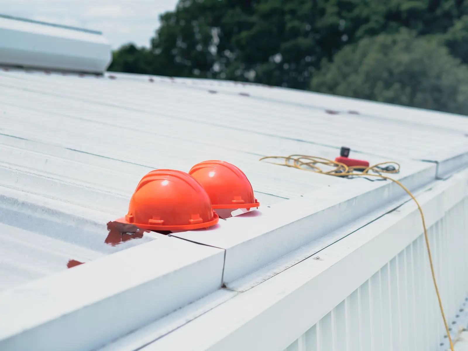 Safety helmets and fixings laid out on a standing seam roof