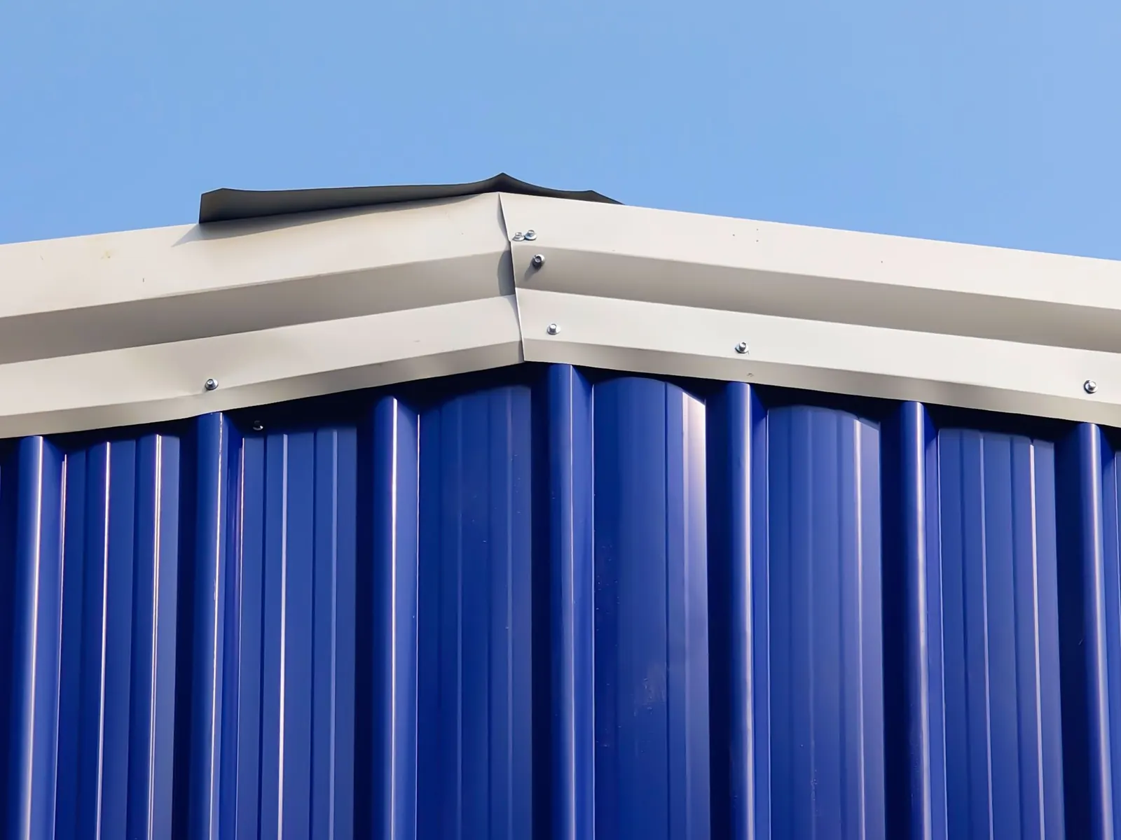 Ridge and eaves detail of a profiled metal roof