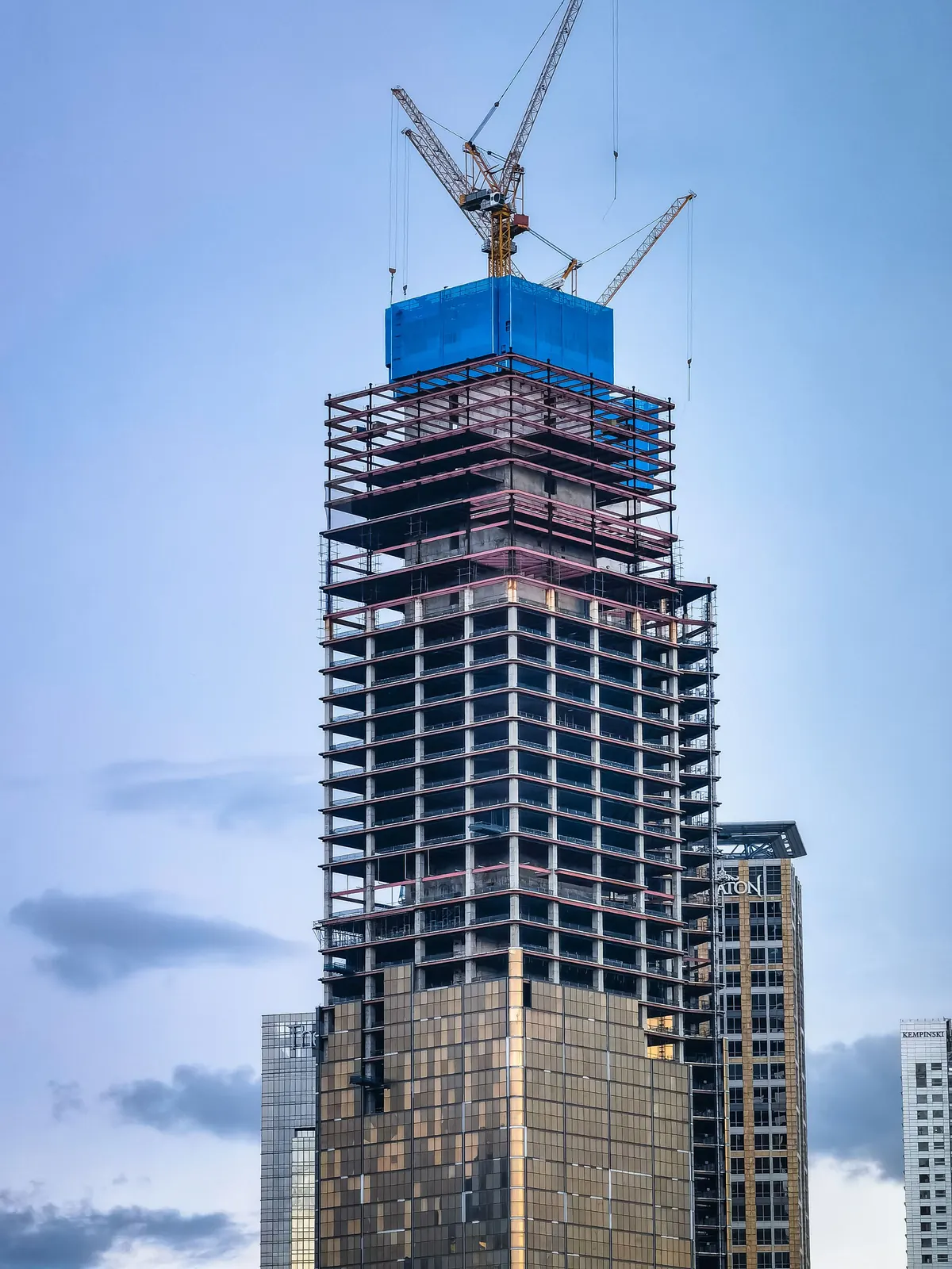 Multistorey steel-framed tower under erection with tower cranes