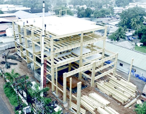 High rise steel frame rising floor by floor over a live site