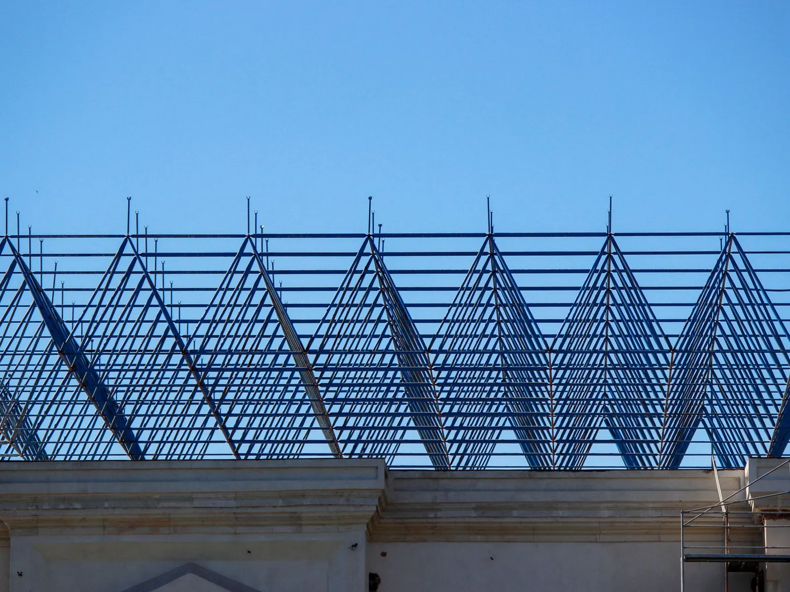 Steel roof trusses and purlins against the sky