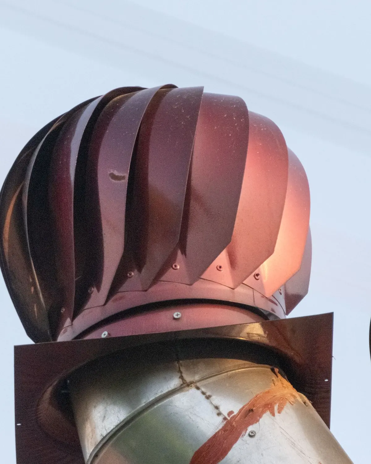Turbine ventilators turning above a roof line